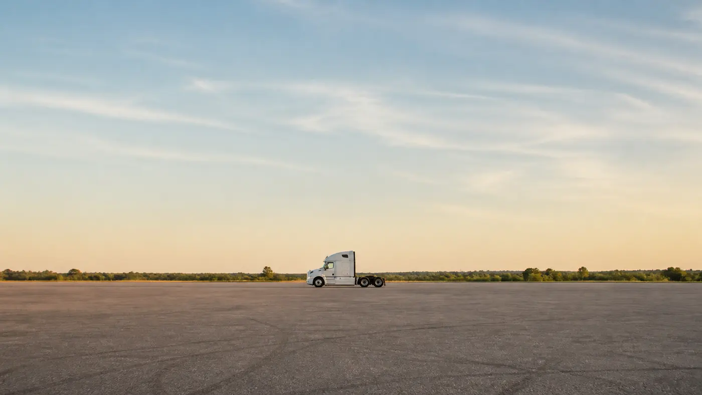 A single new tractor unit standing alone on an open lot